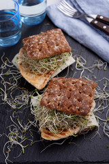Sandwiches with grilled turkey, cheese, and leek sprouts