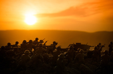 War Concept. Military silhouettes fighting scene on war fog sky background, World War Soldiers Silhouettes Below Cloudy Skyline At night. Attack scene. Armored vehicles. Tanks battle