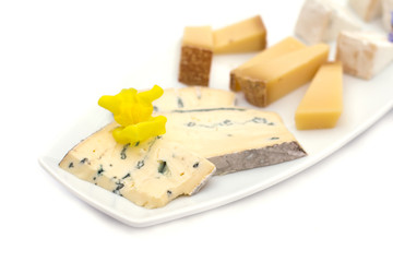 Cheese plate with different kinds of cheese with flowers.