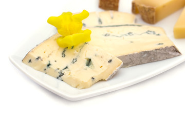 Cheese plate with different kinds of cheese with flowers.