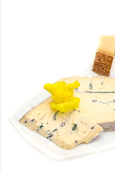 Cheese plate with different kinds of cheese with flowers.