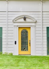 Yellow door, white house