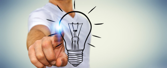 Businessman touching a sketch lightbulb