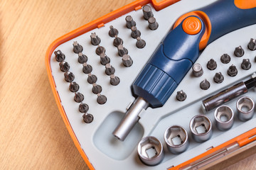 Set heads under the nut. Metal bits and flat-head screwdriver. Tool kit for home use. Nozzles and adapters for screwdrivers. Set heads under the screwdriver