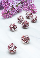 Lilac blossom branches and bliss balls on Carrara marble countertop