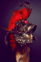 Mannequin in helmet with red feathers