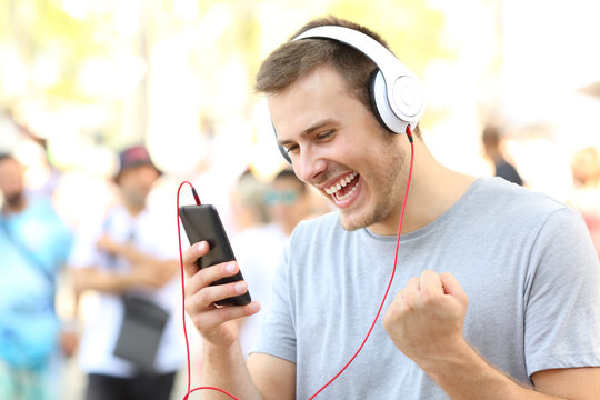 Excited guy receiving good news on phone
