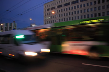 Fototapeta premium The bus and minibus traffic at dusk along the street with motion blur 
