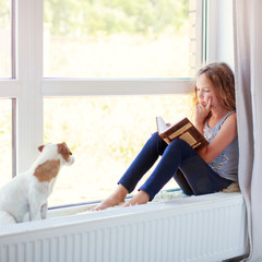 Girl reading book at home