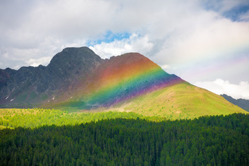Beautiful rainbow among the peaks of the Dolomites Mountains, Italy