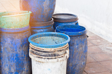 Naklejka premium dirty white and blue garbage bin with copyspace on the left