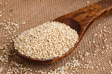 Organic Quinoa seeds on wooden spoon