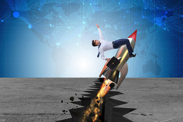 Businessman flying on rocket from rock gap