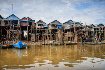 Fototapeta na wymiar Cambodian river houses on stilts form an entire village.