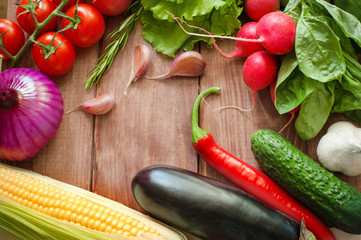 Vegetables and spices. Wooden background. From the side.