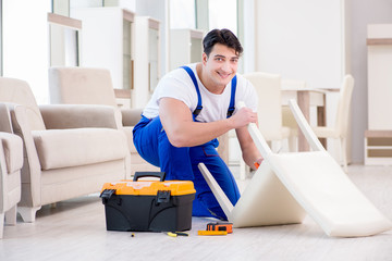 Furniture repairman working in store