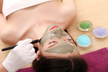 Obraz na płótnie Canvas Cosmetology spa facial. Beautiful brunette in a spa salon