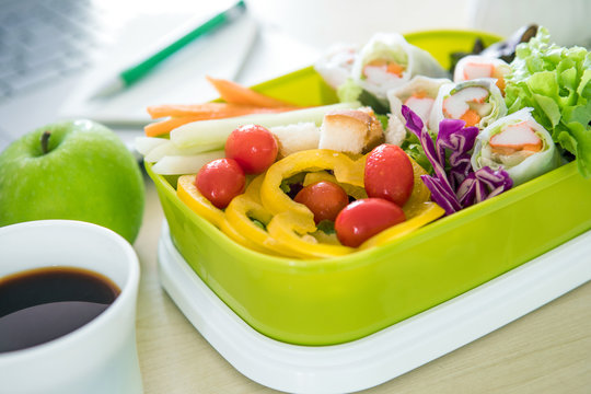 Close up green Lunch box on the work place of working desk ,Healthy eating clean food habits for diet and health care concept