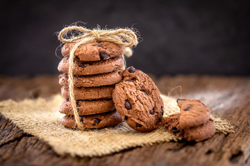Still life of Close up stacked chocolate chip cookies on  napkin with rustic background
