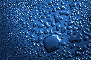 The Abstract water drop on surface of  fresh dark elegance blue background