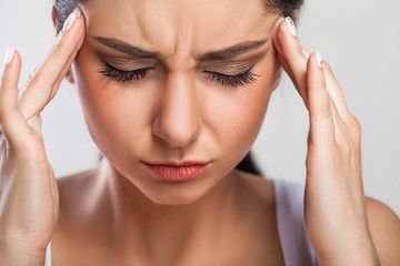 Fototapeta premium Health And Pain. Stressed Exhausted Young Woman Having Strong Tension Headache. Closeup Portrait Of Beautiful Sick Girl Suffering From Head Migraine, Feeling Pressure And Stress. High Resolution Image