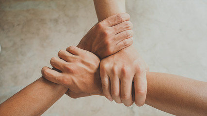 Three human join hands together, collaboration concept of business and education teamwork, soft focus and vintage color tone process