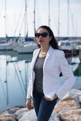 Woman dressed in nautical style in yacht marina