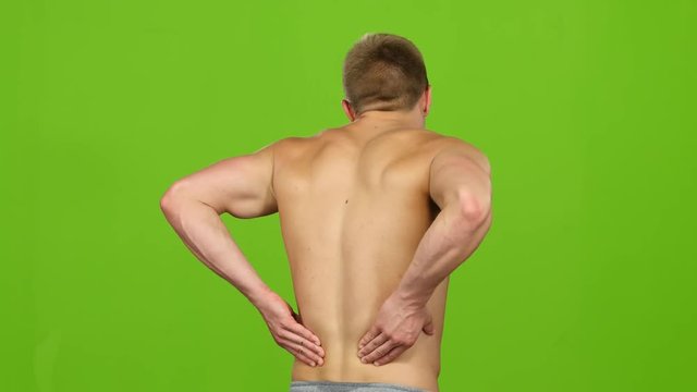 Severe back pain, man suffering from backache having painful cramps