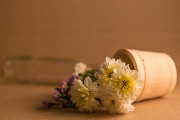 Fototapeta na wymiar Colorful flowers in the wooden bucket