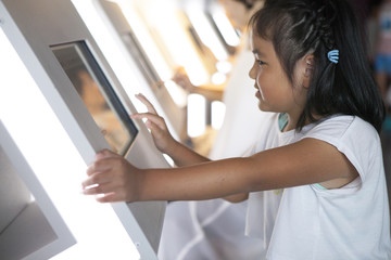 The girl is operating the touch panel computer