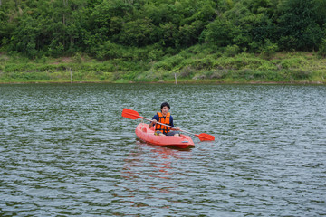 Man paddling in a kayak boat in Thailand