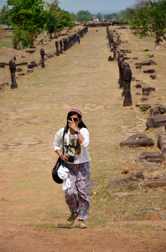 Traveler thai woman travel visit and shooting photo at archaeological site Wat Phu or Vat Phou