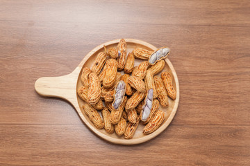 boiled peanuts on wooden plate
