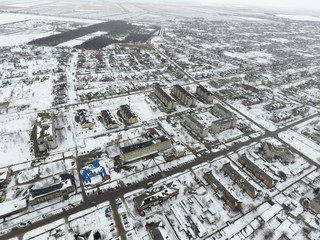 Winter view from the bird's eye view of the village. The streets are covered with snow