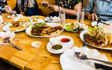 people meeting eating steak and salad