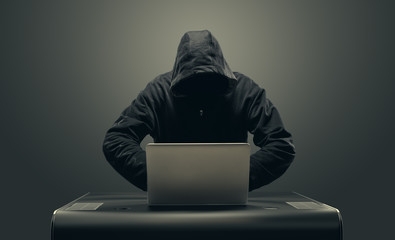 Hacker working with laptop hacking network
