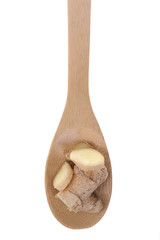 Ginger roots on a bamboo spoon.
