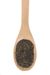 Green tea on a bamboo spoon, isolated on white.