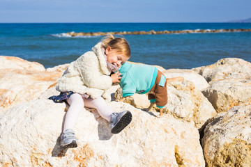 Happy little girl playing with dog