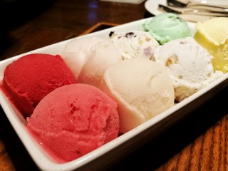 Variety of Ice cream scoops in a bowl, Close up of Multi-color ice cream on wood table. Top view, selective focus. 