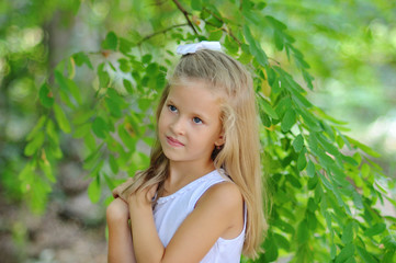 Portrait of a little girl on a green background.