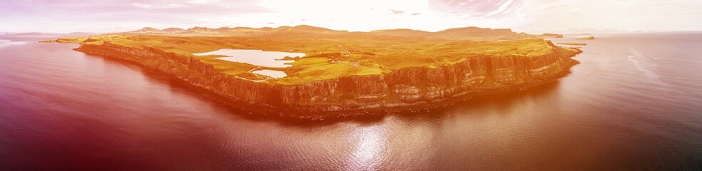 Cinematic aerial shot of the dramatic coastline at the cliffs close to the famous Kilt Rock waterfall ,Skye