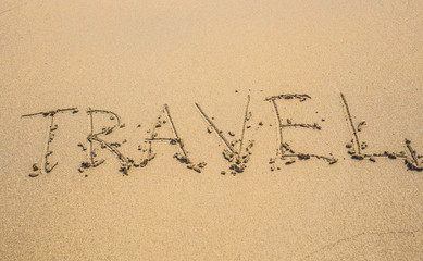 written words travel on sand of beach in summer day