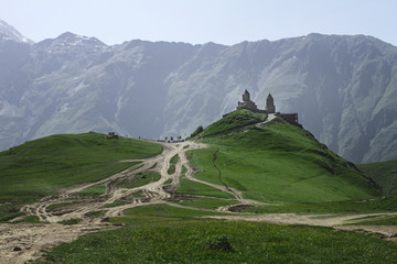 Gergeti Trinity Church of the Holy Trinity on the mountain in Georgia in summer on a mountain...