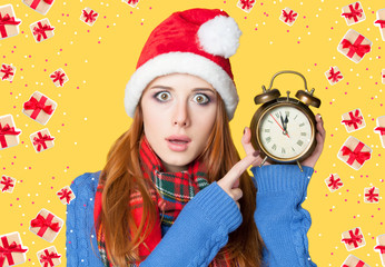 Redhead girl with alarm clock on yellow background.