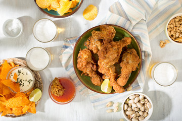 Fried chicken, beer , snacks to beer on white wooden table