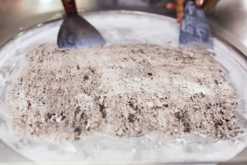 Thailand stir-fried ice cream rolls at freeze pan. Organic, natural rolled ice cream, hand made dessert.