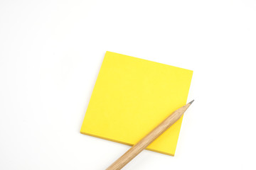 yellow sticky note with brown pencil