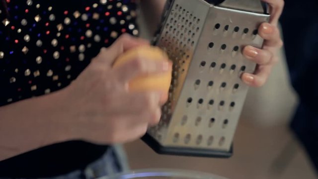 Lemon zest being grated and added to dough ingredients