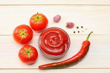 tomato, chili pepper, spices and ketchup on wooden table. top view